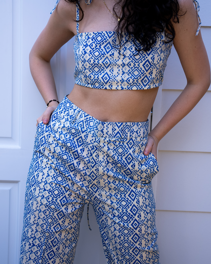 Close-up of Aroa crop top and Marisa pant waistband with pockets, blue geometric hand-printed cotton 