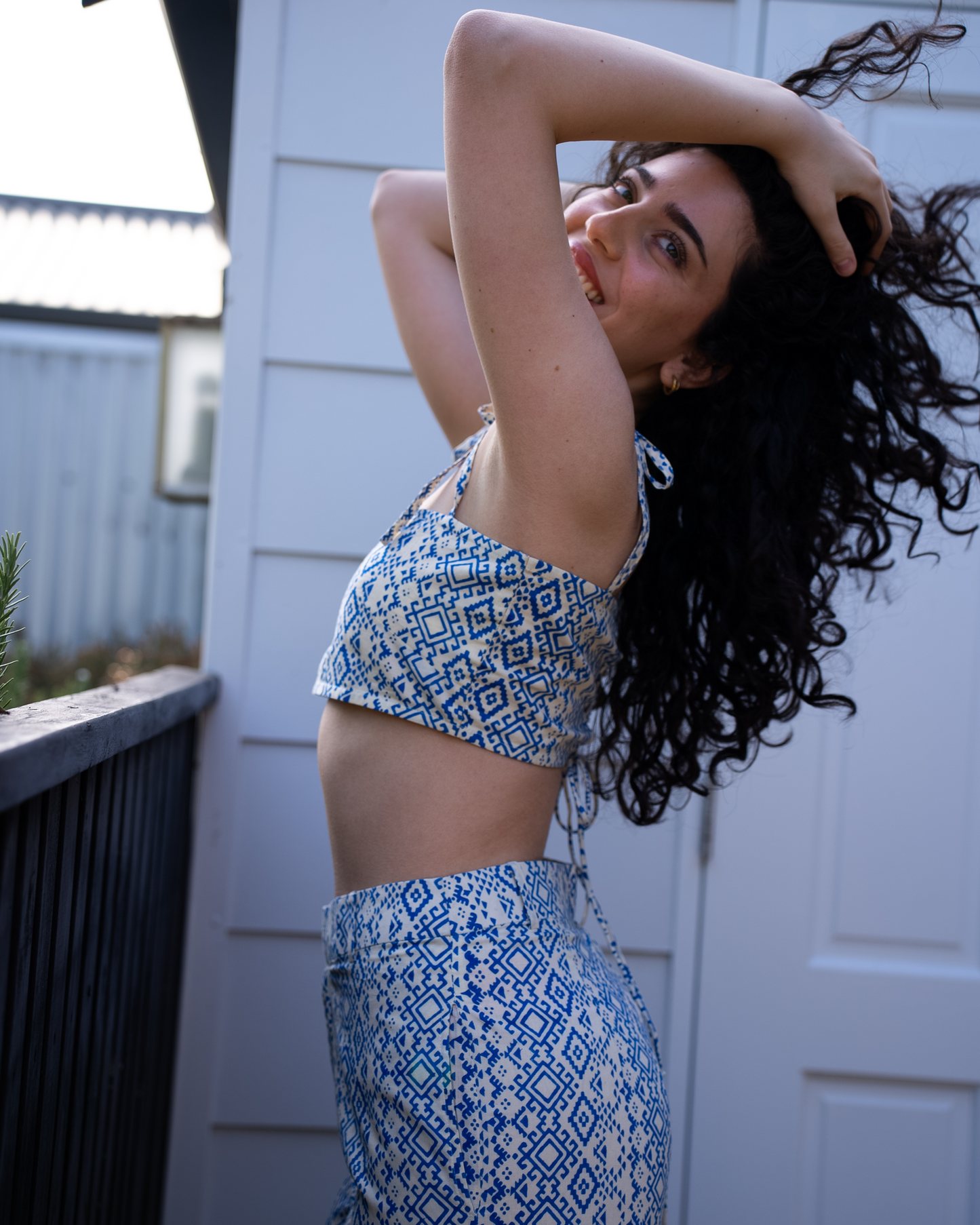 Side profile of Aroa crop top and Marisa pant set, blue geometric print cotton co-ord with tie straps 