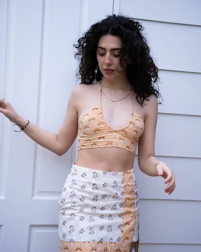 Front view of Jaipur halter crop top with Sunrise high-waist mini skirt, orange floral block print and white base panel