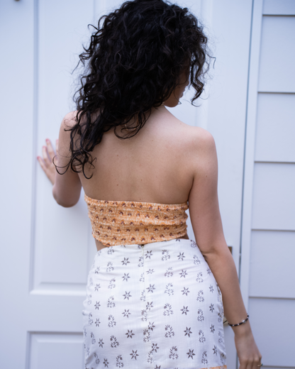 Back view of Jaipur halter crop top and Sunrise mini skirt set, showing back fit and white floral print fabric