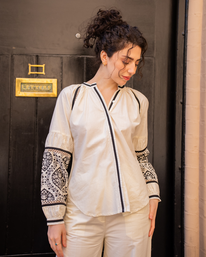 Front mid-length shot of Sophia blouse with Mughal-inspired block print on sleeves, styled with matching wide-leg pants
