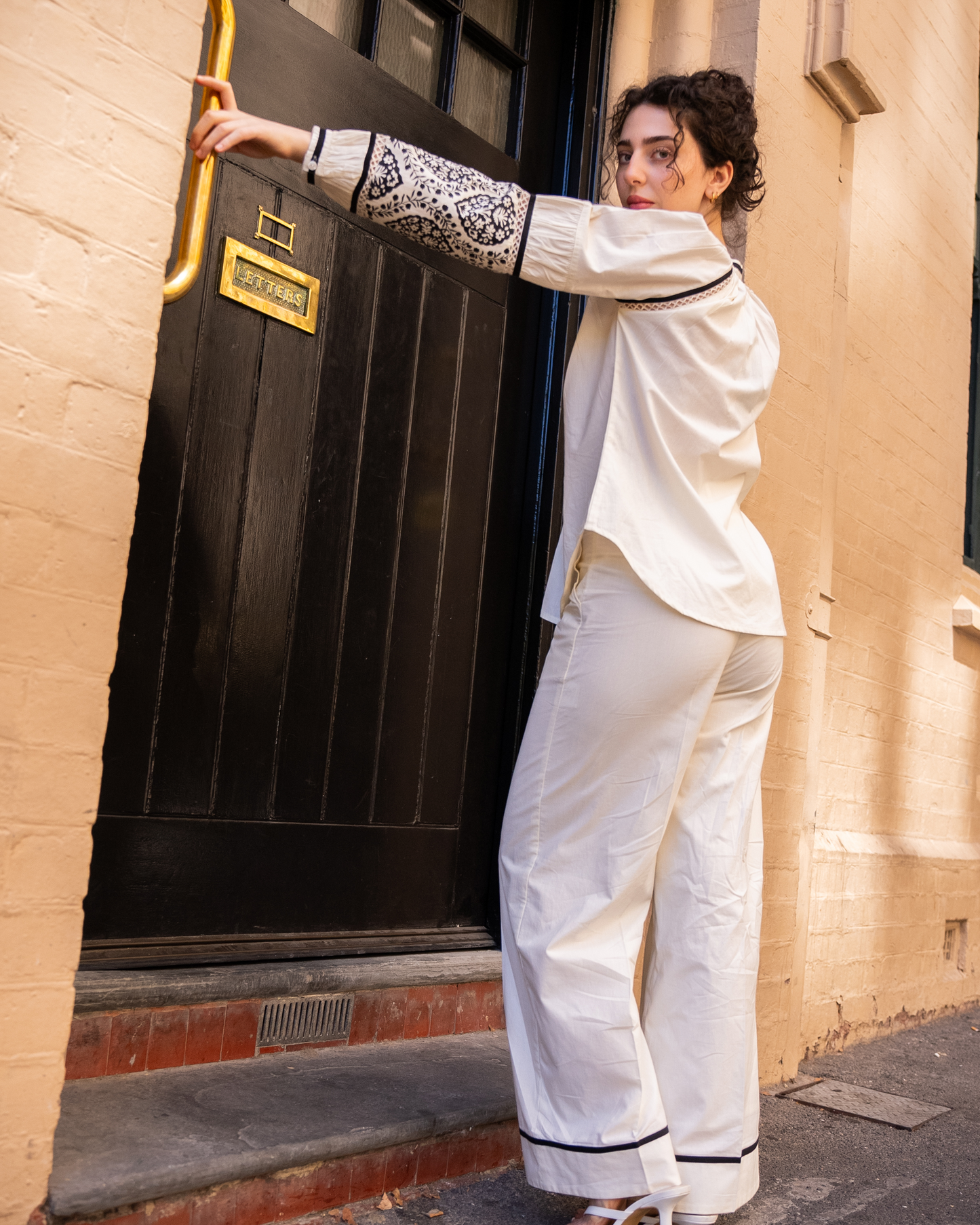 Side/back full outfit of Sophia co-ord set, white cotton blouse with block-printed sleeves and wide-leg pants