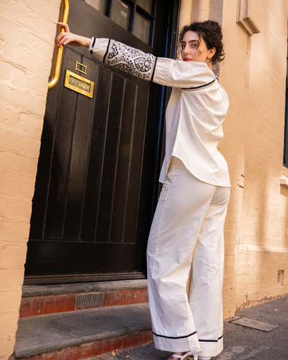 Side/back full outfit of Sophia co-ord set, white cotton blouse with block-printed sleeves and wide-leg pants