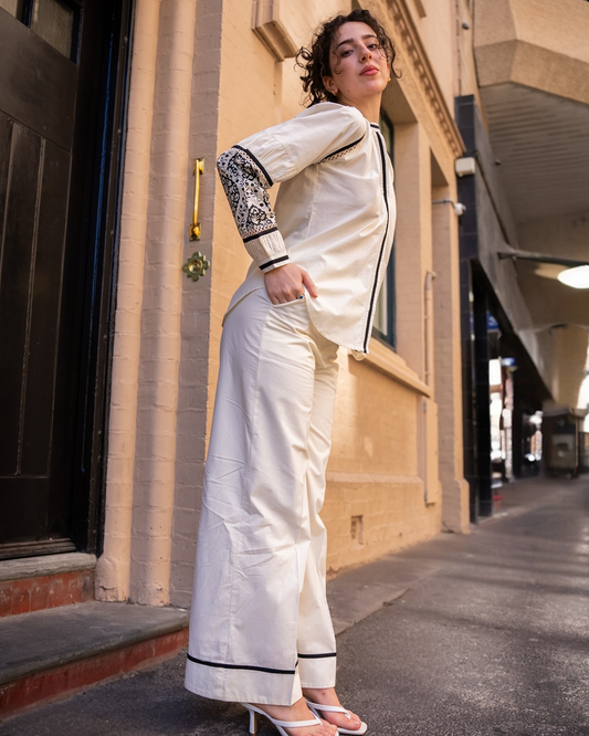 Side view of Sophia pant showing high-waist wide-leg silhouette, black and white cotton pants