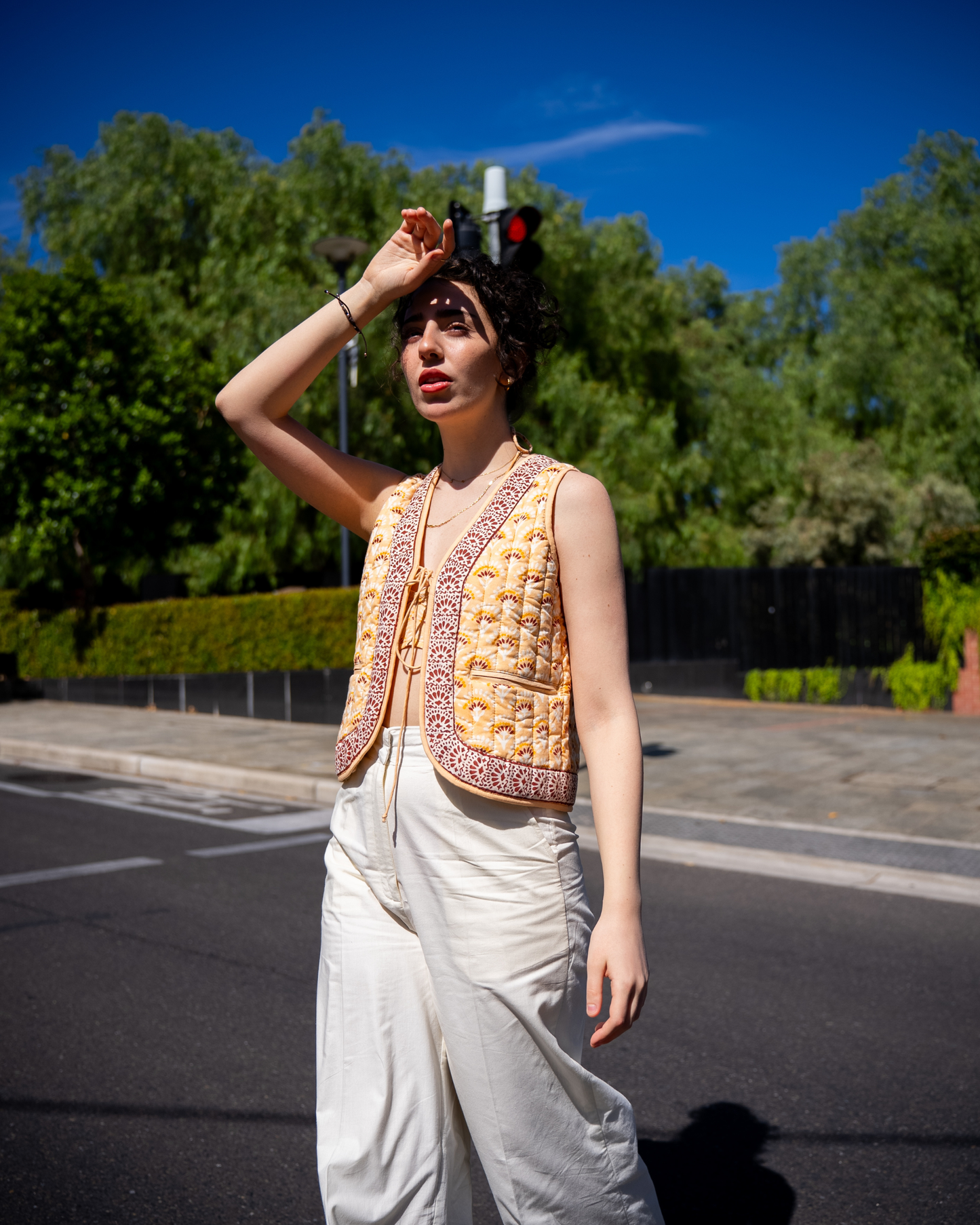 Boho Bay Half Sleeve Quilted Jacket – lifestyle front view seated, showing V-neck border trim, drawstring tie and quilted block print